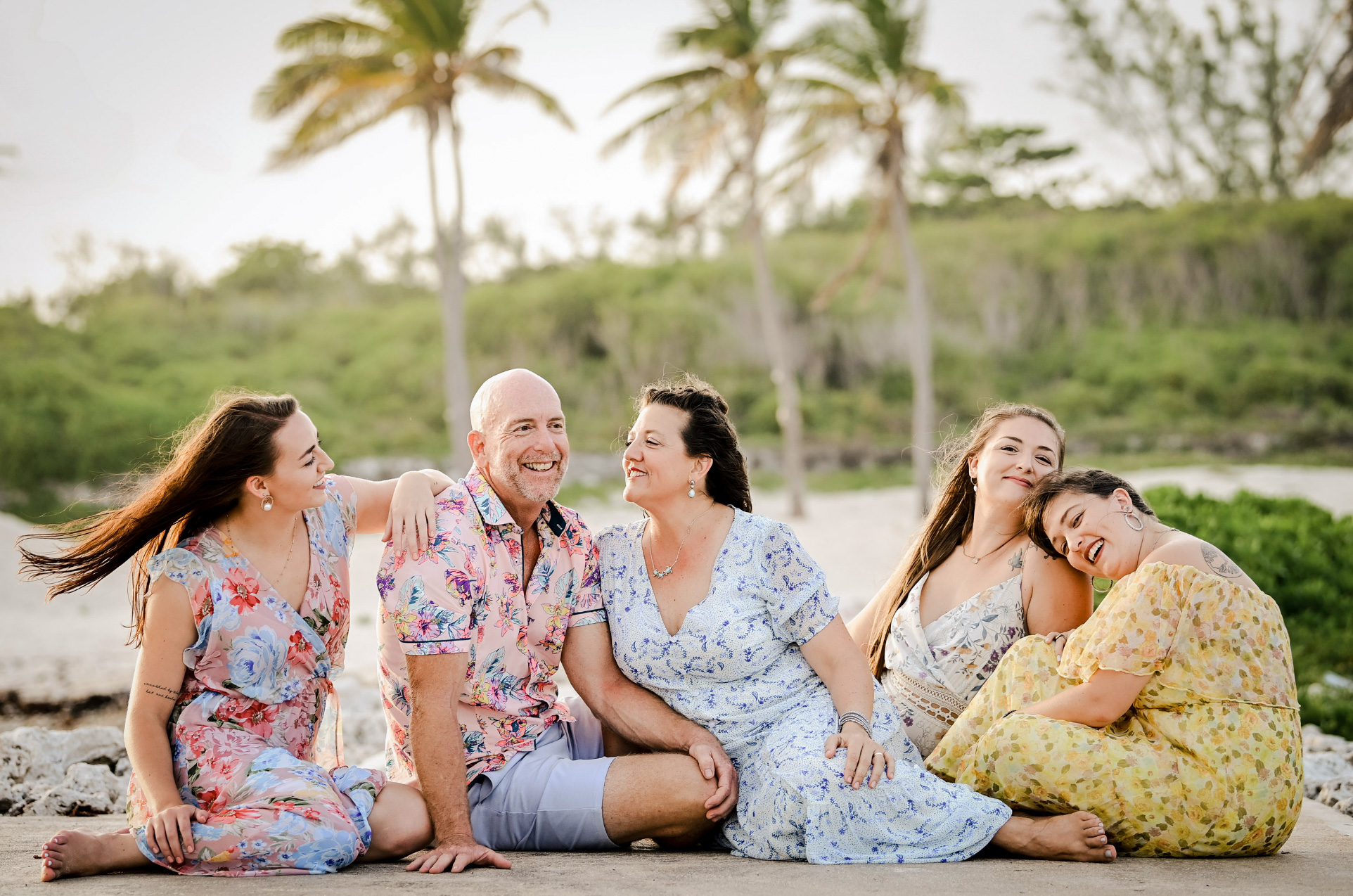Family group laughing together on a Grand Cayman beach