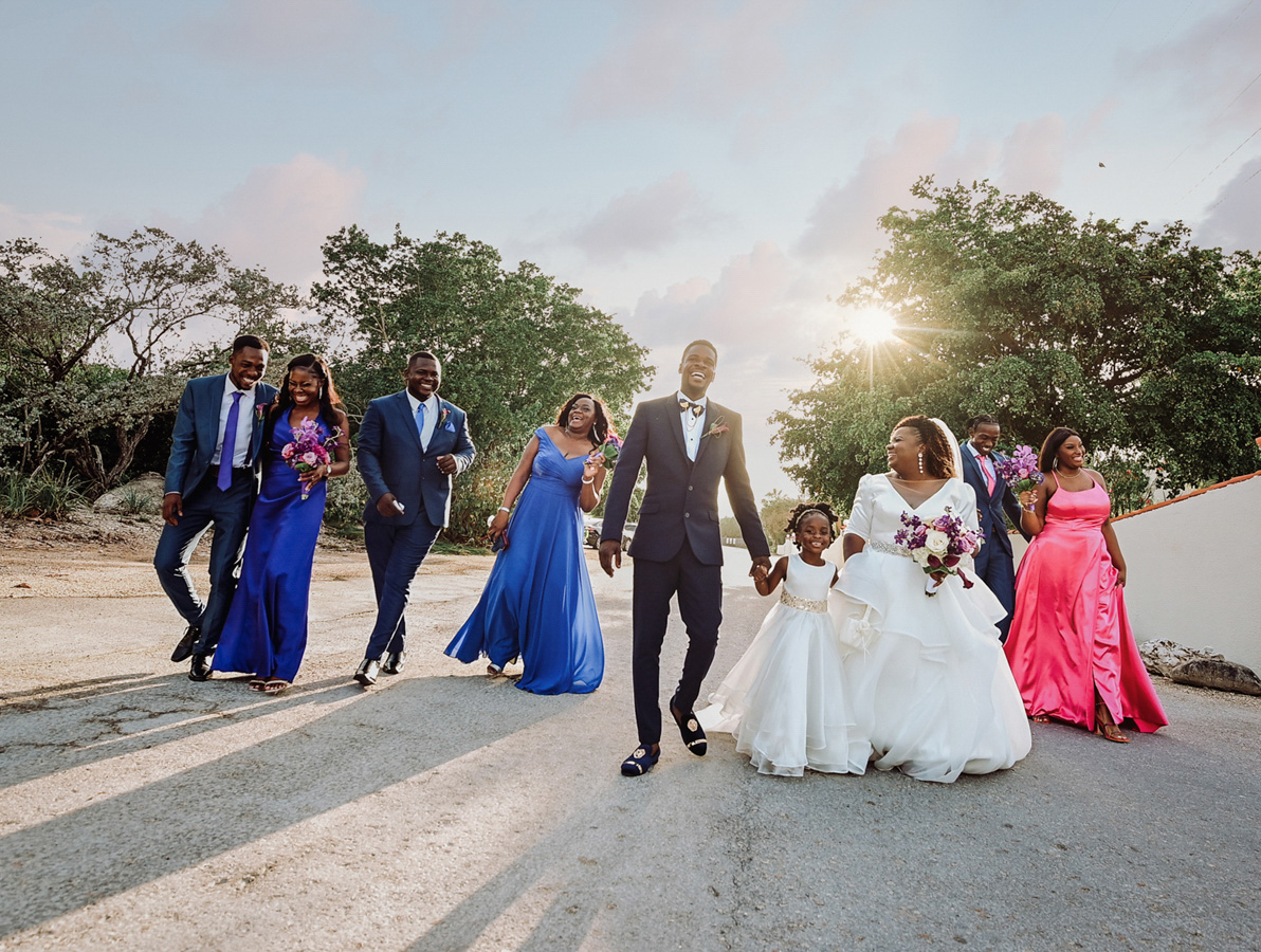 Wedding party walking together in warm island light