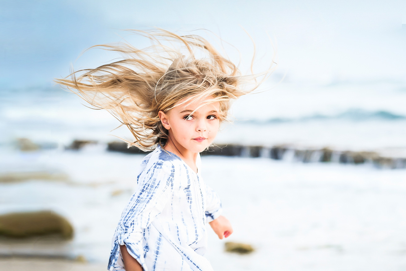 Wind-swept child portrait on a Grand Cayman beach