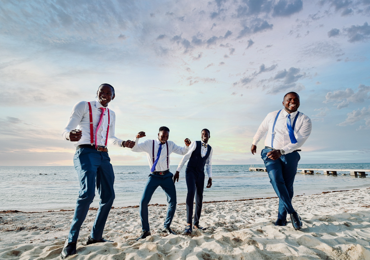 Groomsmen celebrating on a Grand Cayman beach